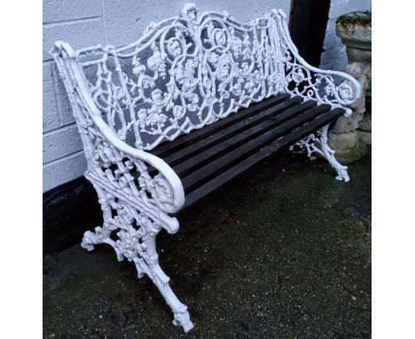 A Coalbrookdale style&nbsp;rustic leaf scroll pattern garden bench, painted white, slatted wood seats on conforming sides 