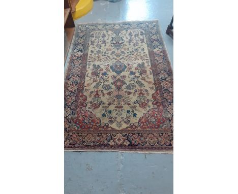 Persian design carpet on a cream and navy ground decorated with flowers and foliage.  203x132cm approx.  (B.P. 21% + VAT) 