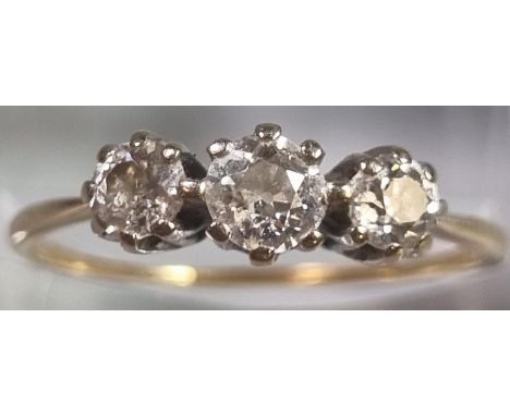 Gold diamond three stone ring. 2g approx. Size R. (B.P. 21% + VAT)  The ring is not marked.  There is a break in the shank.