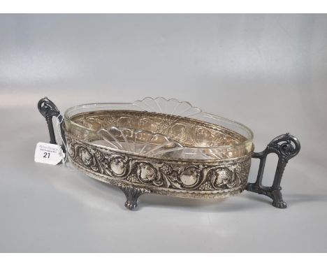 WMF style silver plated two handled centre bowl/dish with glass liner of oval form decorated with relief fruits and foliage. 