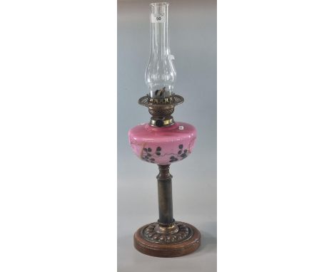 Early 20th century double oil burner lamp having pink opaline glass and floral reservoir on a copper and wooden base. (B.P. 2