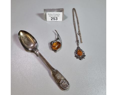 Silver pierced foliate design pendant with amber coloured stone on chain, silver coloured pin brooch with amber coloured ston