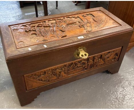 20th century camphor wood trunk/chest ornately carved with figures amongst pagodas. (B.P. 21% + VAT)  Dimensions: (W) 90 x (D