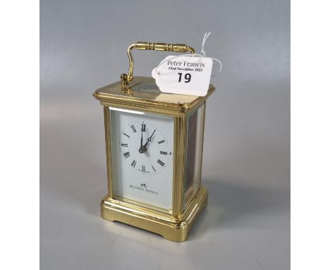 Modern brass carriage clock by Matthew Norman, with key.  (B.P. 21% + VAT) The glass panel on the reverse has broken and is r