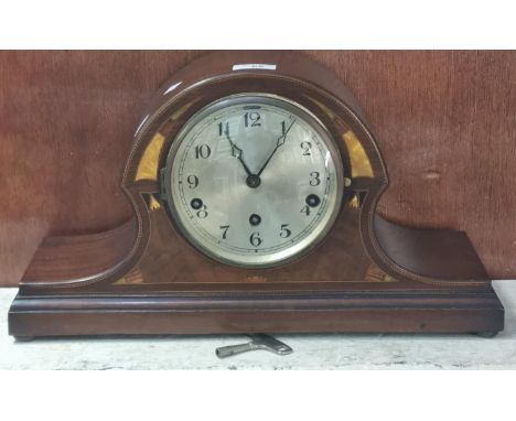 Edwardian inlaid mahogany three train arched mantle clock with silvered Arabic face.  25cm high approx.    (B.P. 21% + VAT) 
