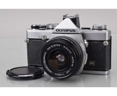 An Olympus OM-1n SLR Camera, shutter working, meter responsive, self timer working, body G, some paint wear to edges, with G 
