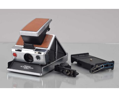 A Polaroid SX-70 Alpha 1 Camera, tan, body F-G, untested, some scuffs, elements G-VG, with 2353 stand