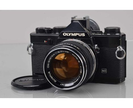 An Olympus OM-1n SLR Camera, black, shutter working, meter responsive, self timer working, body G, two screws missing from ba