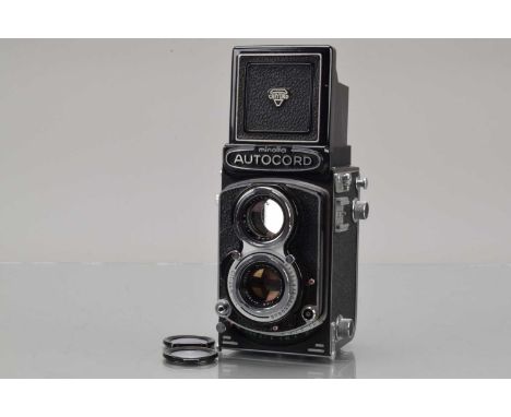 A Minolta Autocord RA TLR Camera, shutter working, self timer working, body G, slight paint wear to back edges, with 75mm f/3