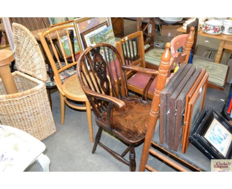 A stick and wheel back elbow chair