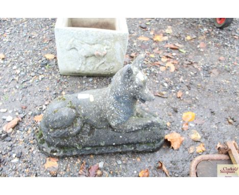A concrete garden ornament in the form of a hound 