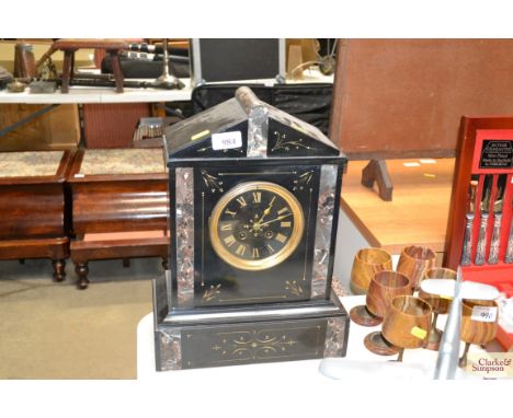 A late Victorian black slate mantel clock