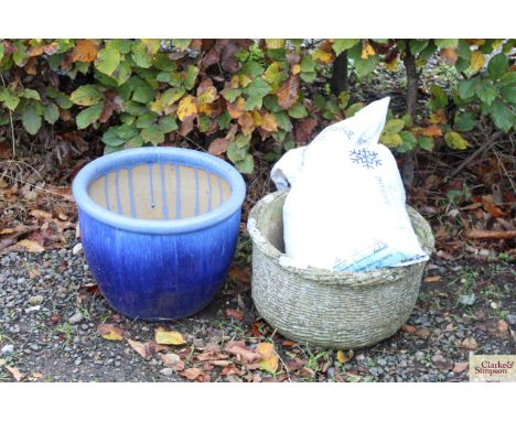 A blue glazed planter; and a concrete planter; and a bag of salt 