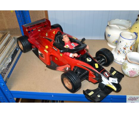 An Action Man toy and a Formula 1 racing car toy