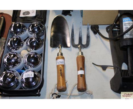 A stainless steel hand trowel and fork (14)