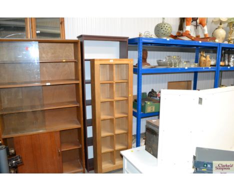 A mahogany effect bookcase and a light oak shelf