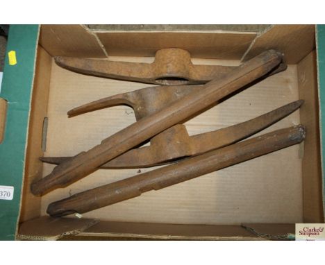 A box containing pick axe heads and two sash weights 