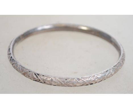 A sterling silver bangle bracelet of circular form having diamond eye decoration. Marked 925. Weighs 13.2 grams and measures 