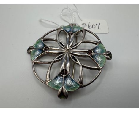 A circular arts and crafts silver and enamel brooch