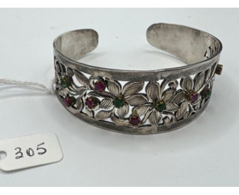 A good multi stone cuff bangle with floral design