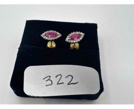 A pair  of ruby and diamond set naivete shaped stud earrings 18ct gold