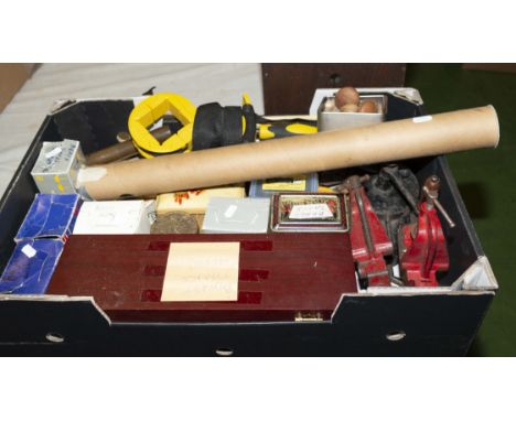 A box containing upholstery tacks, nails, two small bench vice and other upholstery equipment
