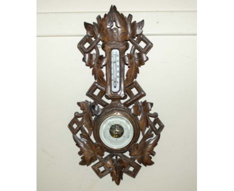 A carved wood barometer