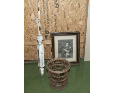 A vintage gate post, cane litter basket and a framed photograph