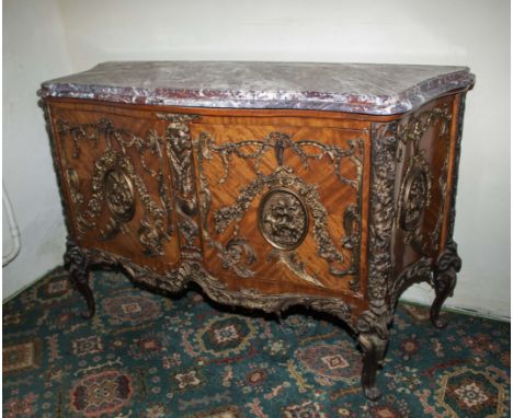 A 20th century French commode in king wood with ormolu mounts and marble top