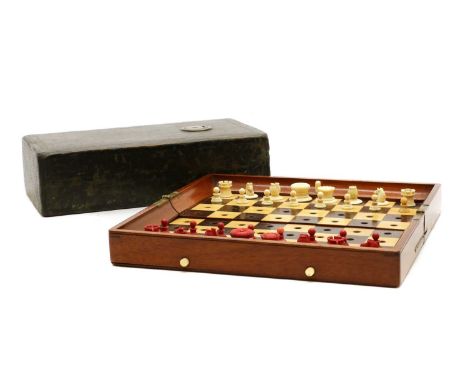 A Jaques bone travel chess set,early 20th century, 'IN-STATU QUO', one side stained, the pieces fitted in a mahogany inlaid b