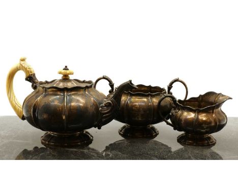 A three piece silver tea service,maker's mark 'WE', London 1825, comprising a teapot, with an ivory handle and finial, 16cm h