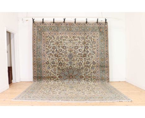 A Central Persian signed Kashan carpet,20th century, foliate motifs to a pale ground,396 x 283cmCondition ReportSlight staini