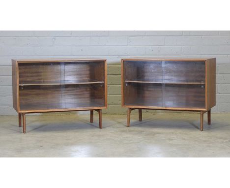 Two teak cabinets, 1960s, each with sliding glass fronts, raised on shaped supports, 91.5cm 45.5cm deep71.5cm high (2)Provena