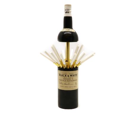 A novelty musical cigarette dispenser,modelled as a Buchann's Black &amp; White scotch bottle, the top lifting up to reveal a