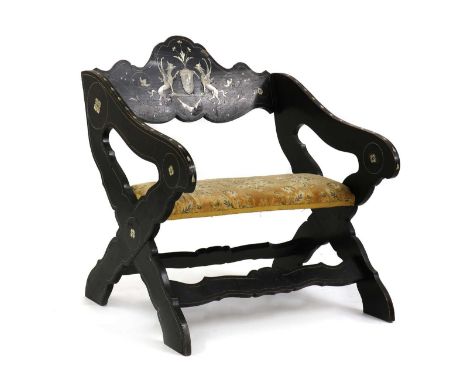 A Italian ebonised X-frame chair, late 18th/early 19th century, profusely inlaid throughout with ivory, the backrest inlaid w