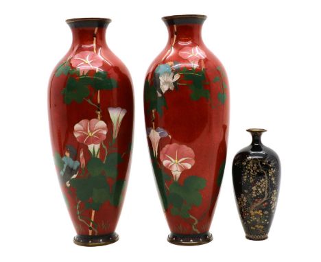 A pair of Japanese cloisonné vases,20th century, with flowers to a red ground, 31cm highand another similar example,decorated