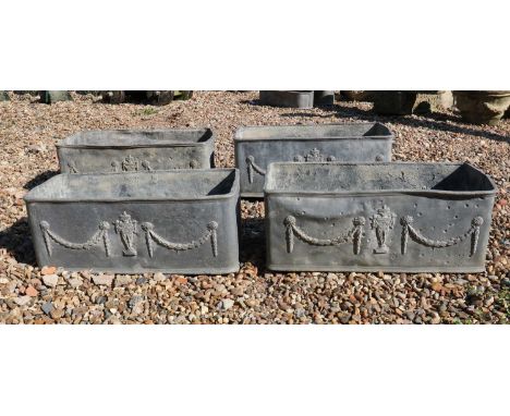 A set of four lead trough planters,20th century, in the Neoclassical taste, with urn and draping swags,67cm wide28cm deep25cm