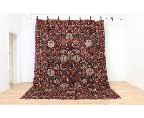 A Bakhtiari carpet,with panels of bird and tree motifs to a red and navy ground,369 x 263cmCondition ReportEven wear. Good pi