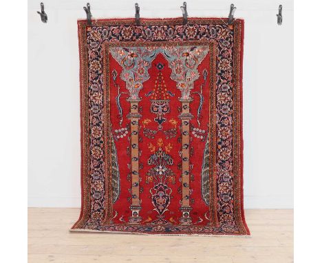 A Persian rug,decorated with a flower-laden vase below a hanging mosque lamp between columns,138 x 208cmCondition ReportHoles