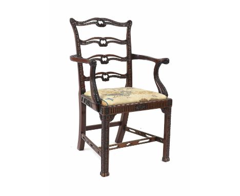 A carved mahogany elbow chair,in the manner of Chippendale, with four pierced splats, over a drop in seat63cm wide99cm highCo