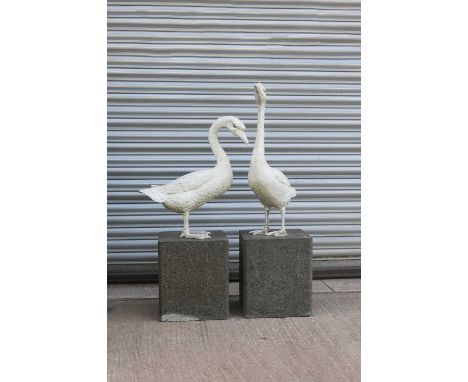 Two painted metal geese,modern, 58cm and 68cm approx, on two reconstituted plinths, 33cm square, 38cm high (4)Provenance: The