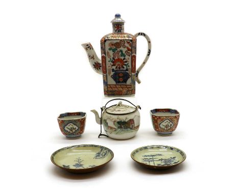 A Japanese Imari wine pot and two cups,19th to 20th Century, decorated in the traditional palette, the wine pot; 23cm higha C