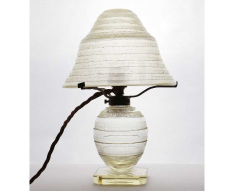 A Daum glass table lamp,20th century, with an etched glass shade and base, raised on a square plinth, etched 'Daum Nancy Fran