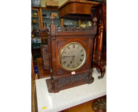 A late Victorian carved oak bracket clock, the 9 inch silvered circular dial inscribed 'J C Jennens & Son, Great Sutton St, L
