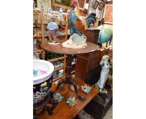 A George III oak circular tilt-top tripod table, 75cm diameter. 