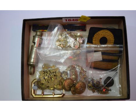 A small quantity of military badges and similar, to include: a compass; and a Metropolitan whistle.