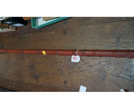 An antique Japanese sword stick, signed in Japanese and indistinctly inscribed Hosodo?, the blade 60cm long, in red lacquered