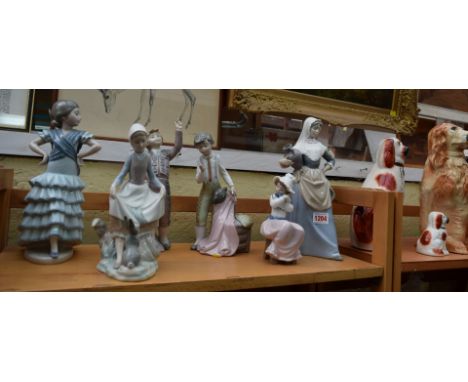 Four Lladro figures; and two similar Nao figures.