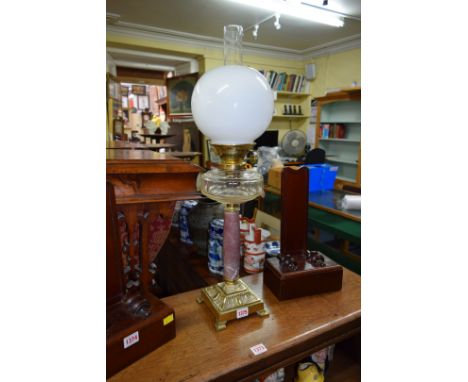An old brass and marble oil lamp.