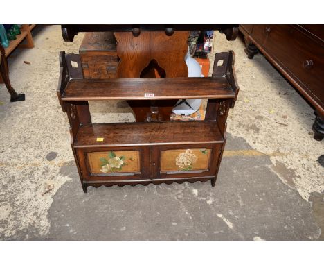 An early 20th century oak and painted hanging shelf, 60cm wide.